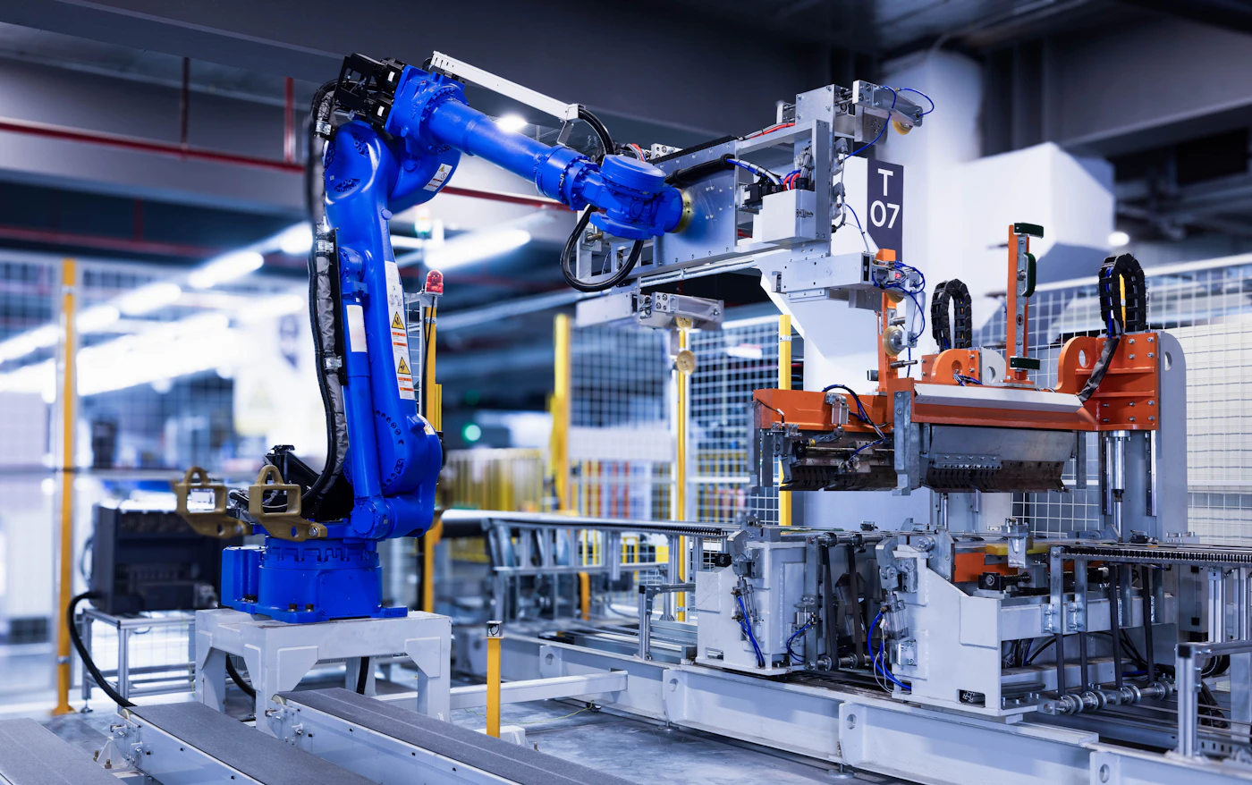Blue industrial robot arm in precision facility