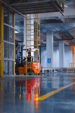 a forklift parked inside of a large warehouse