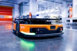 an orange and black vehicle in a garage