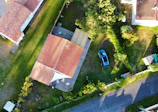 an aerial view of a house with a car parked in the driveway