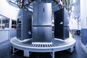 a group of refrigerators sitting inside of a building