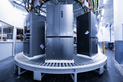 a group of refrigerators sitting inside of a building