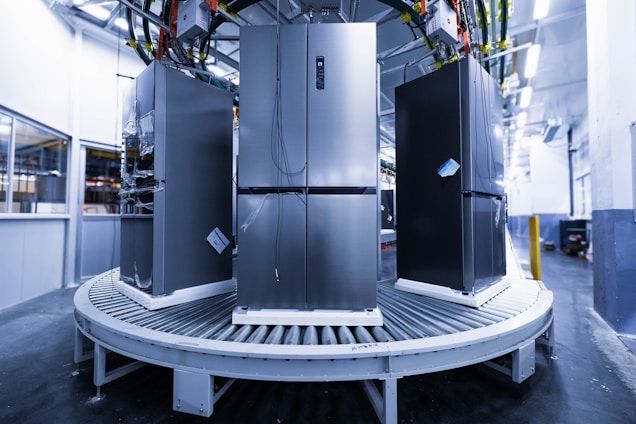 a group of refrigerators sitting inside of a building