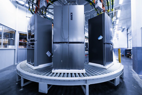 a group of refrigerators sitting inside of a building
