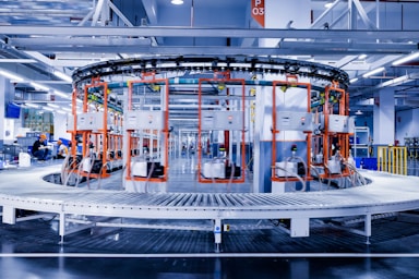 a large machine in a factory with people working on it