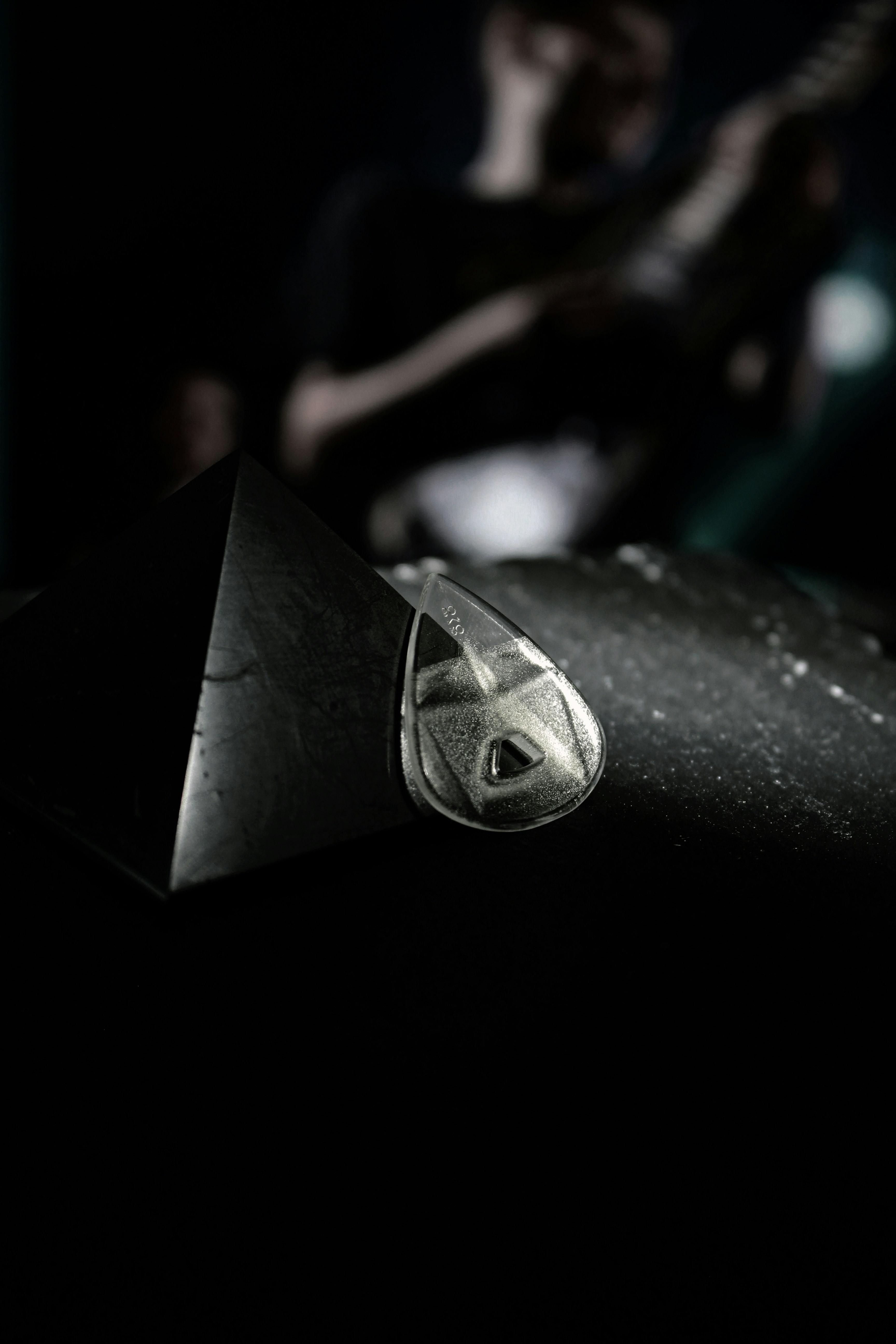 a black and white photo of a person playing a guitar