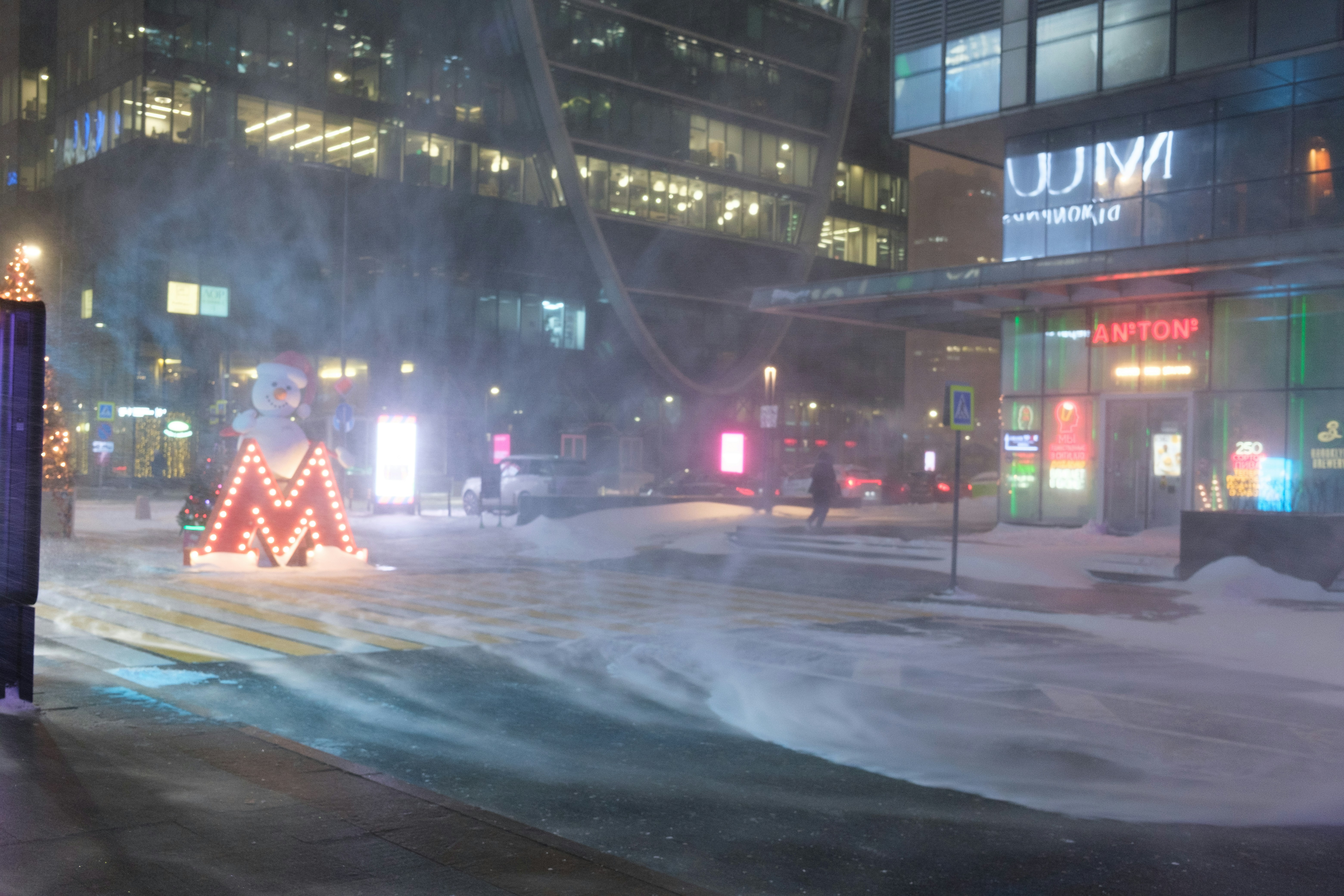a city street is covered in snow at night