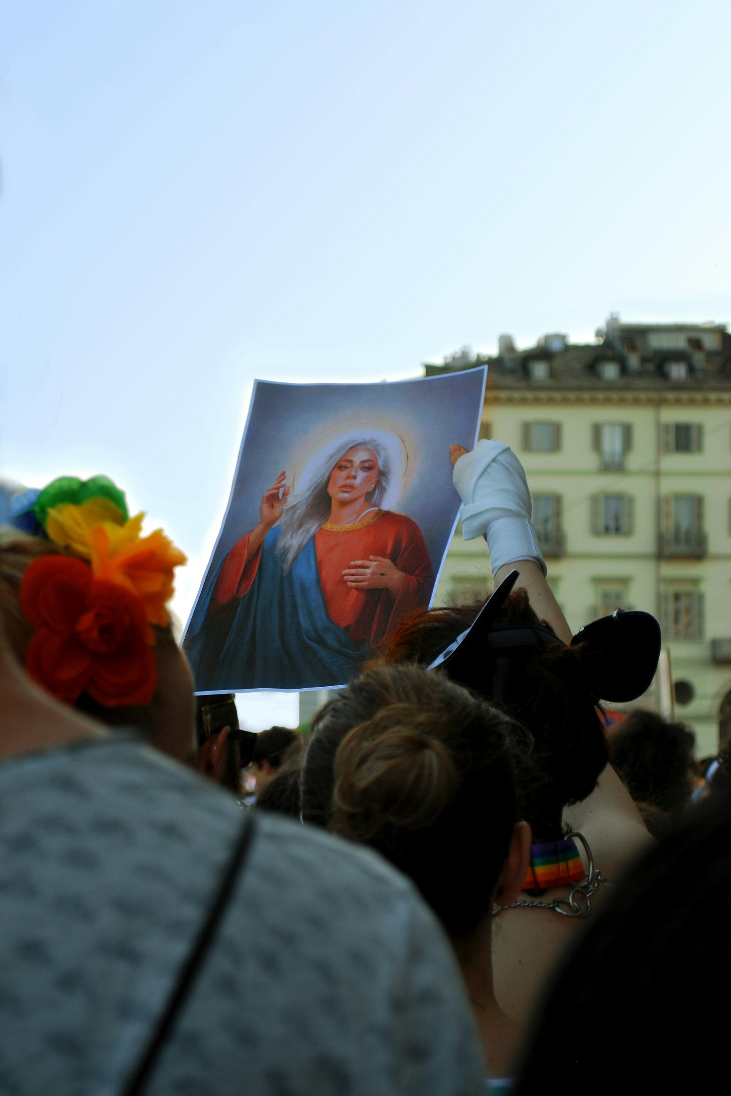 a crowd of people holding up a picture of jesus