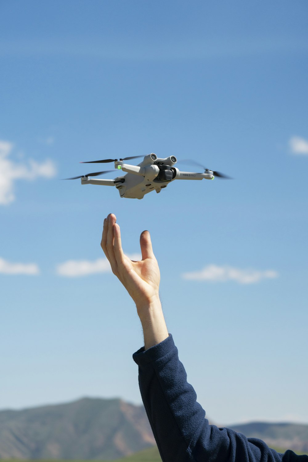 a person holding a remote control plane in their hand