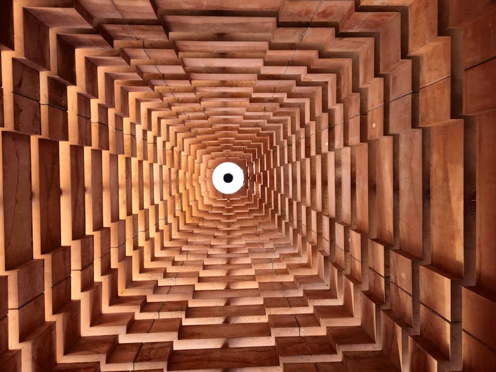 a wooden tunnel with a white circle in the center