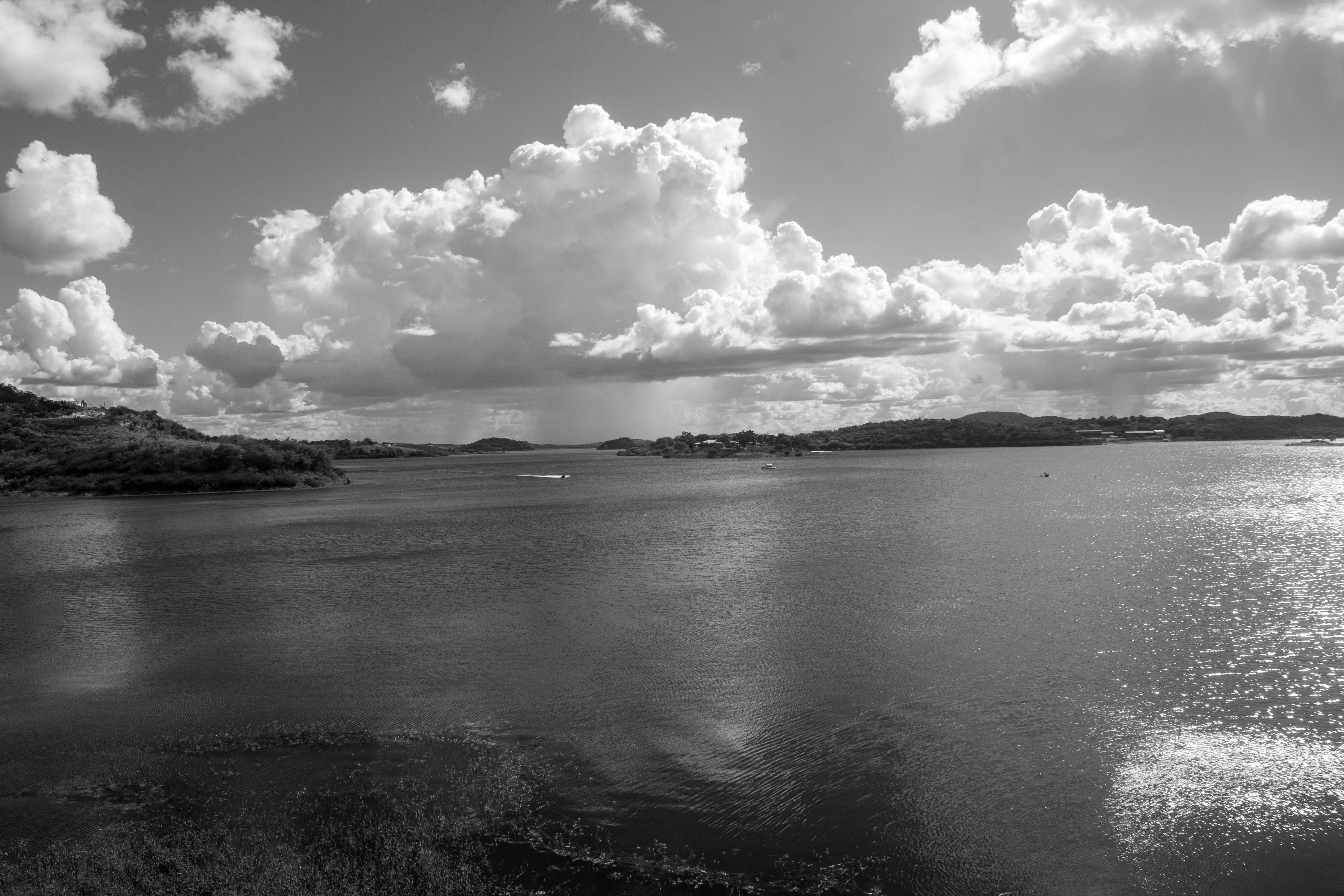 a large body of water surrounded by clouds