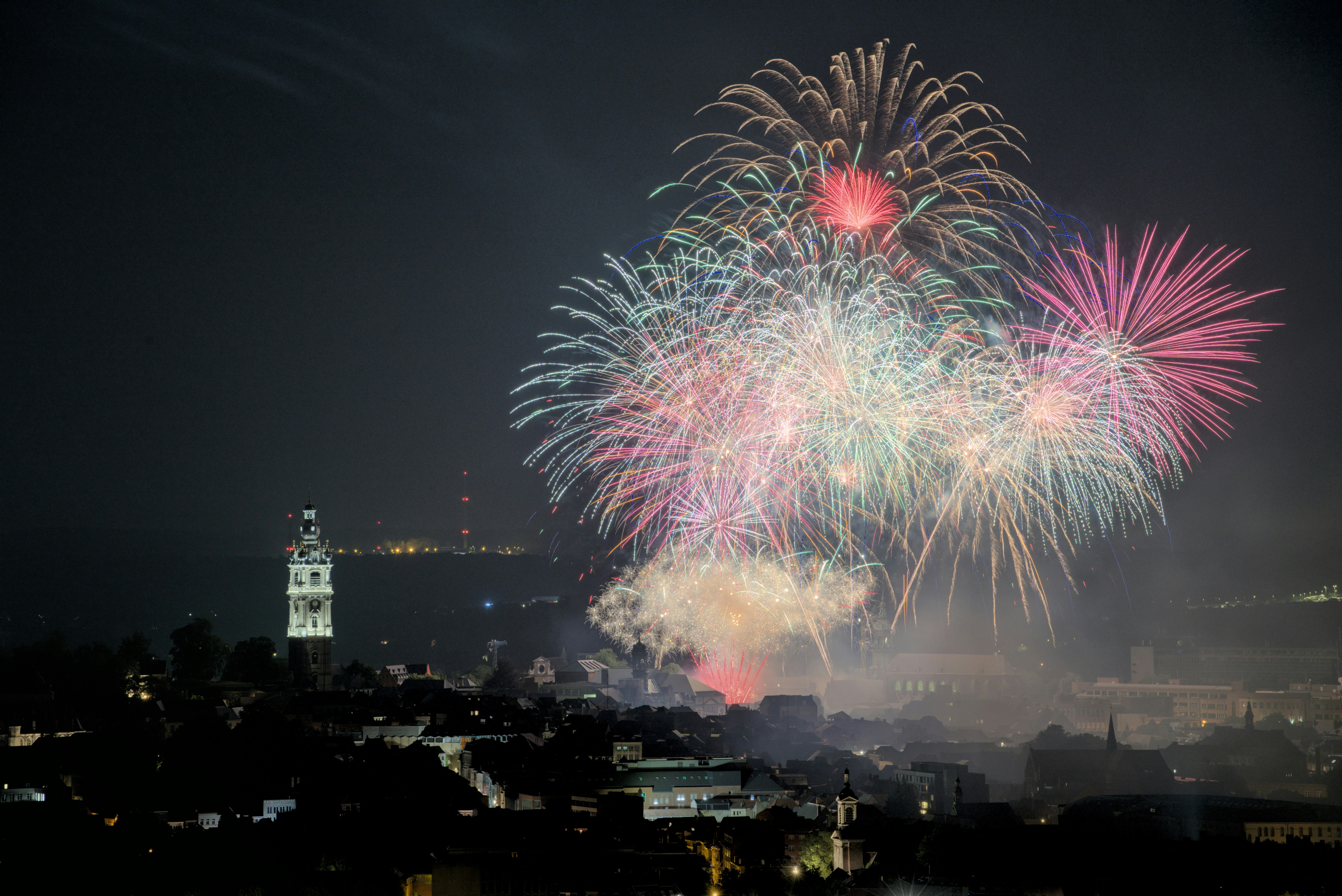 a fireworks display over a city at night