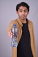 a man holding a bottle of water in his hand