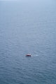 a small boat floating on top of a large body of water