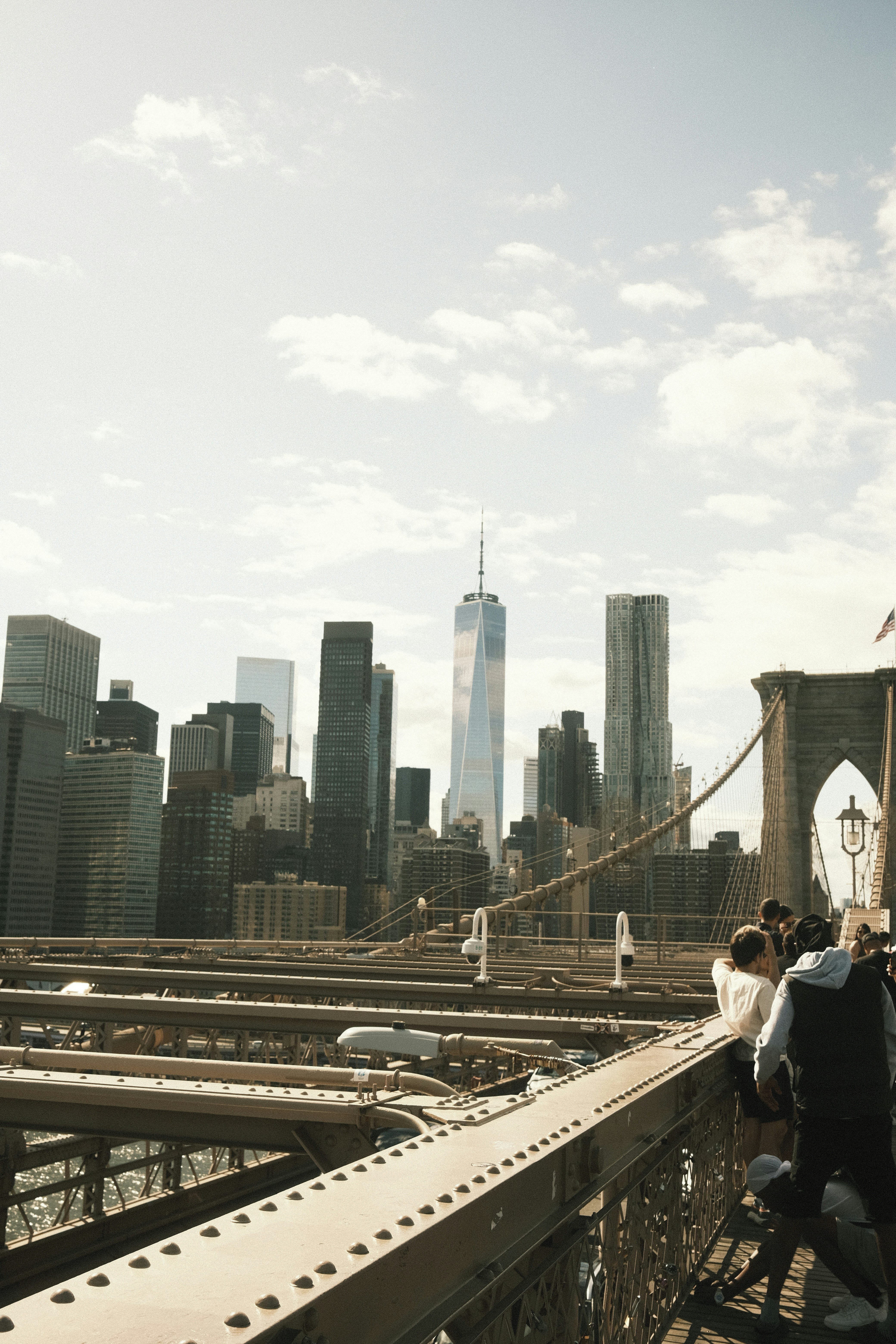 A group of people walking across a bridge photo – Free White Image on ...