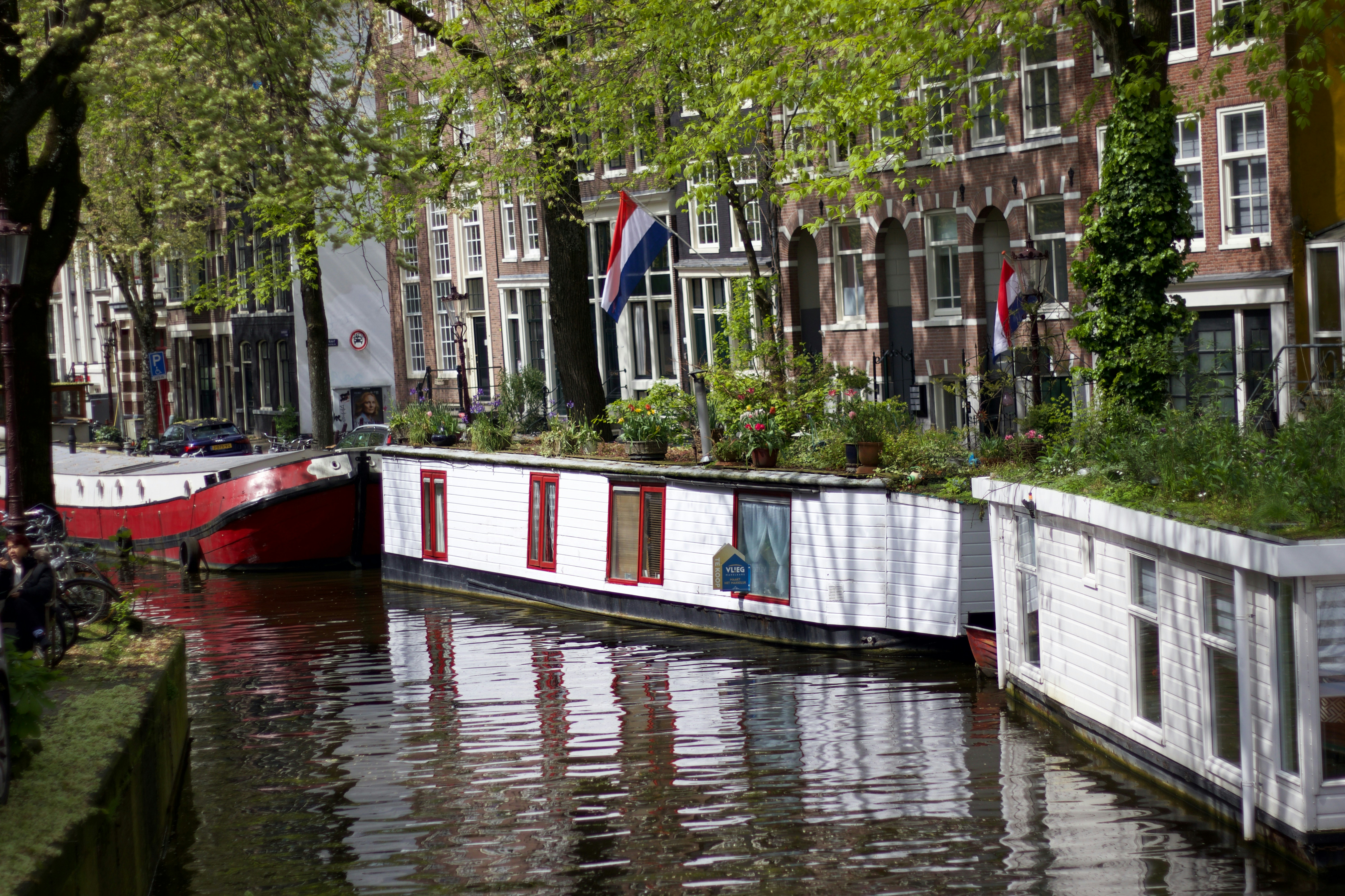a boat is docked on the side of a canal
