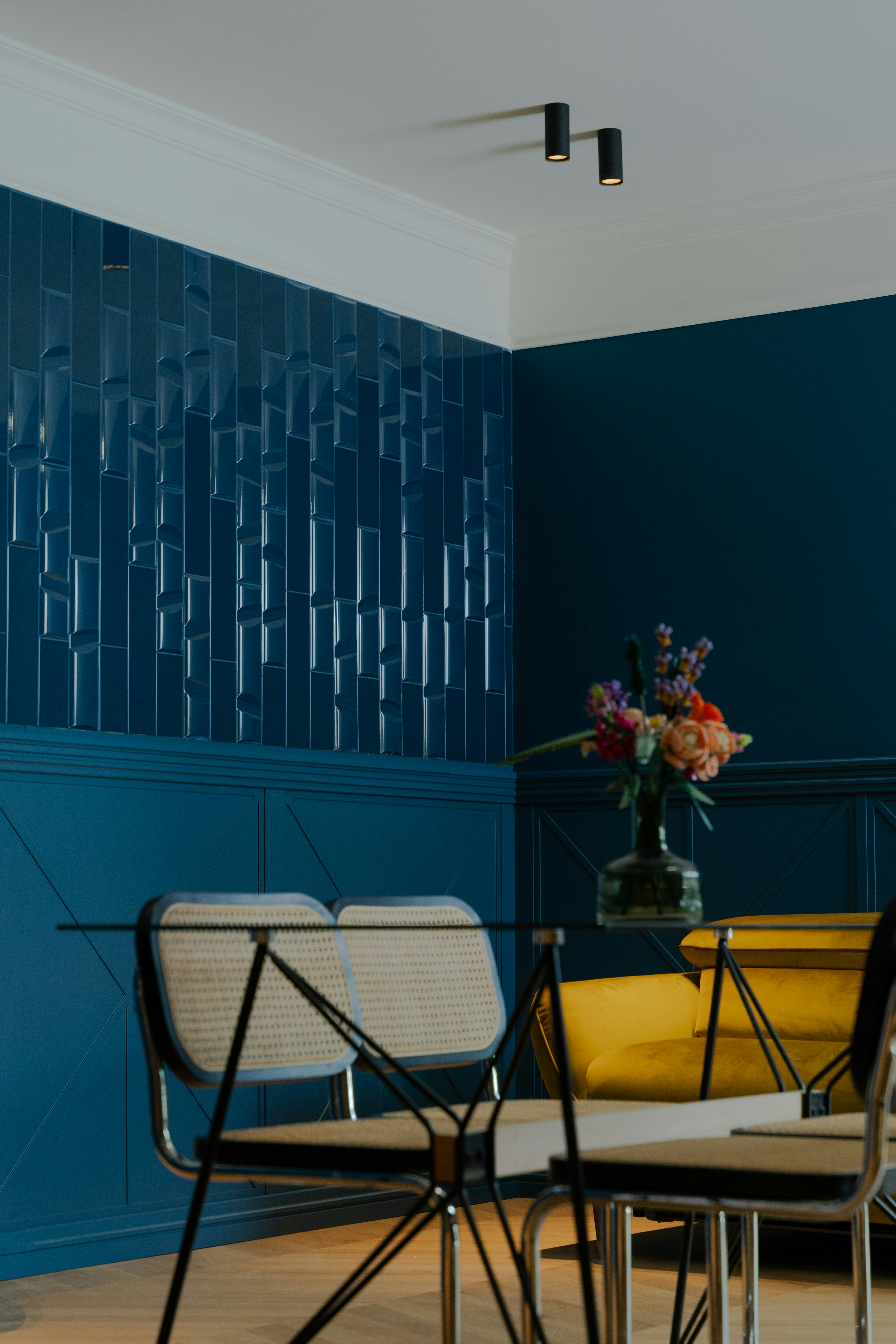 a table and chairs in a room with blue walls
