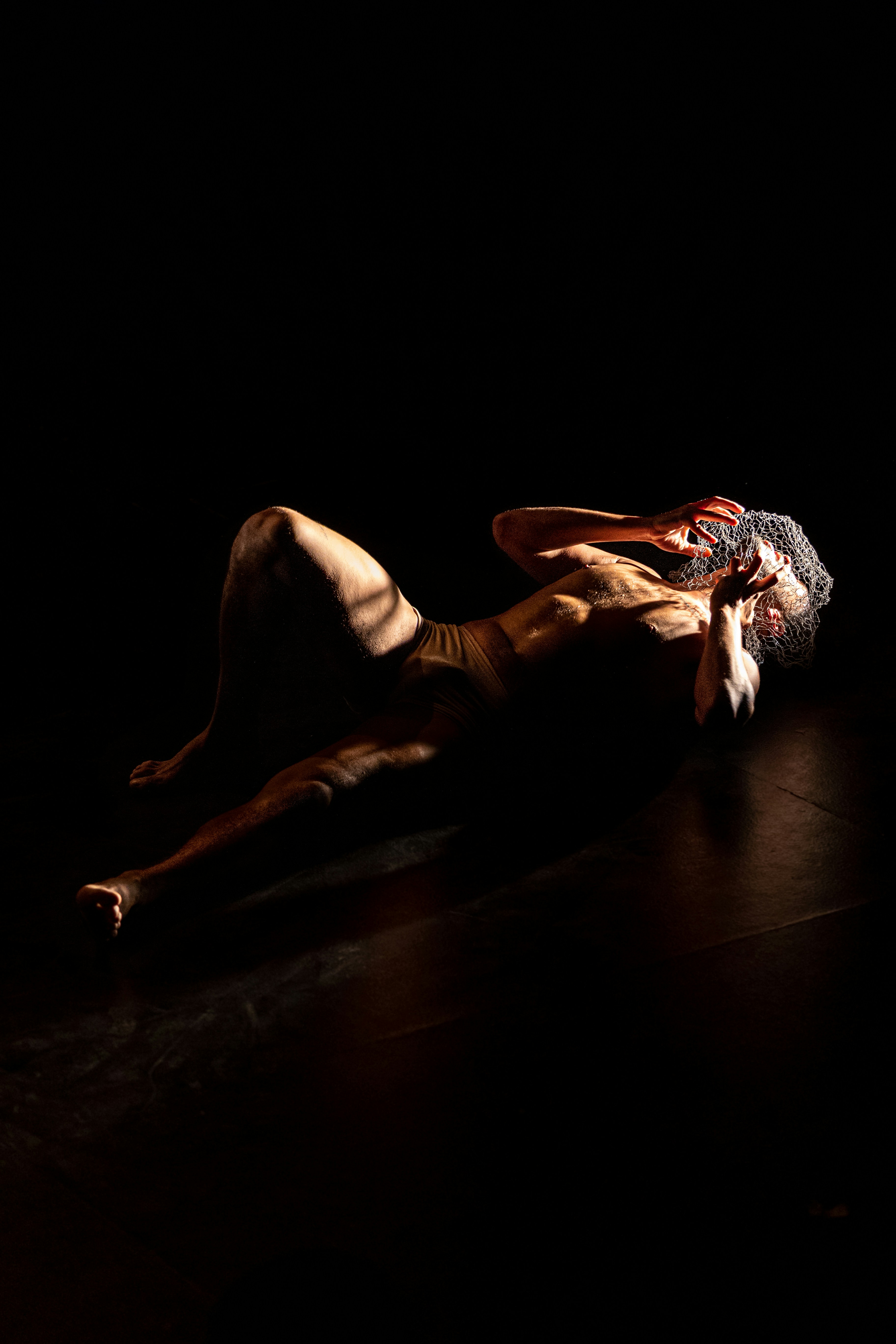 a man laying on the ground in the dark