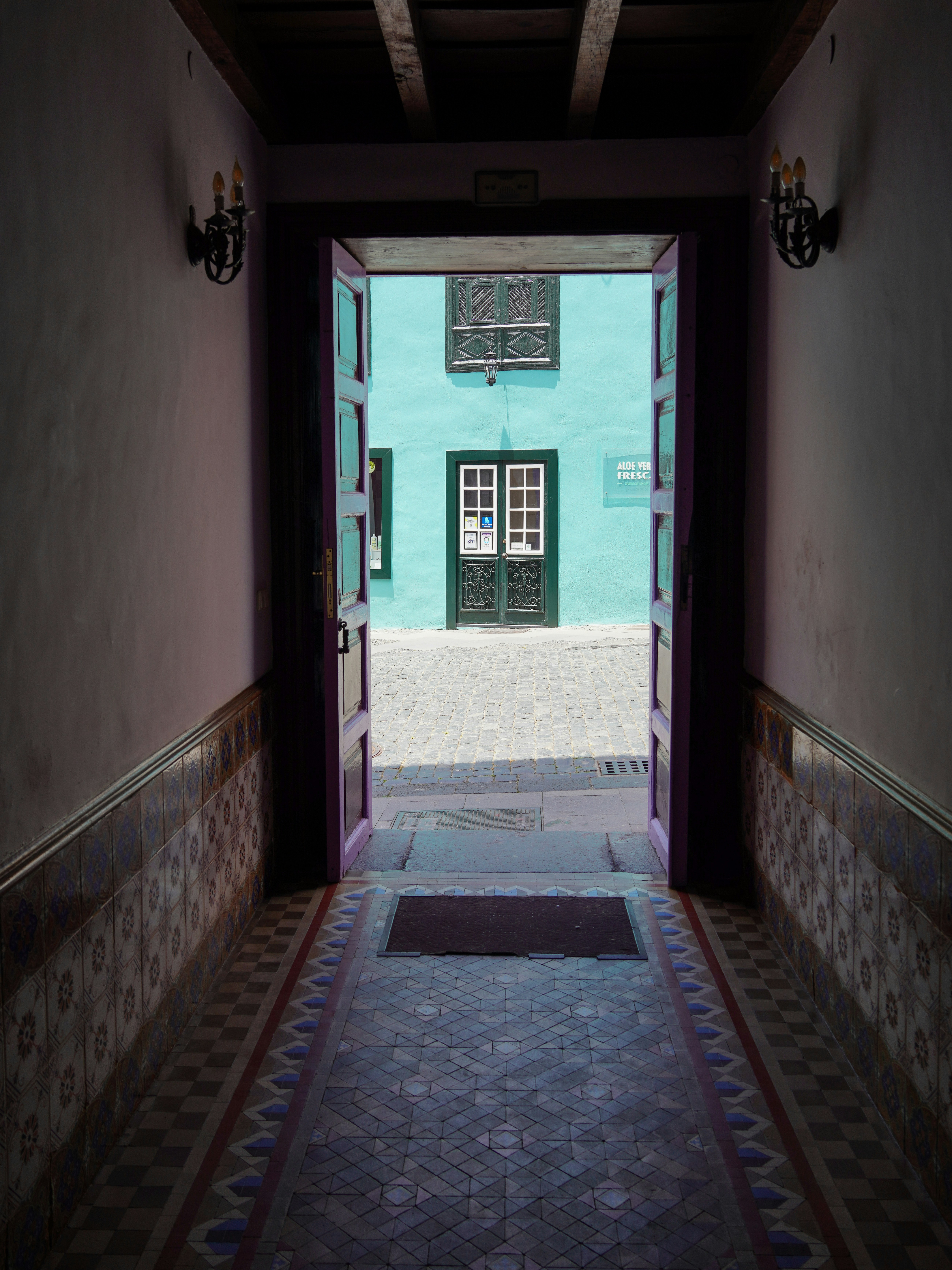 a doorway leading into a building with a tiled floor