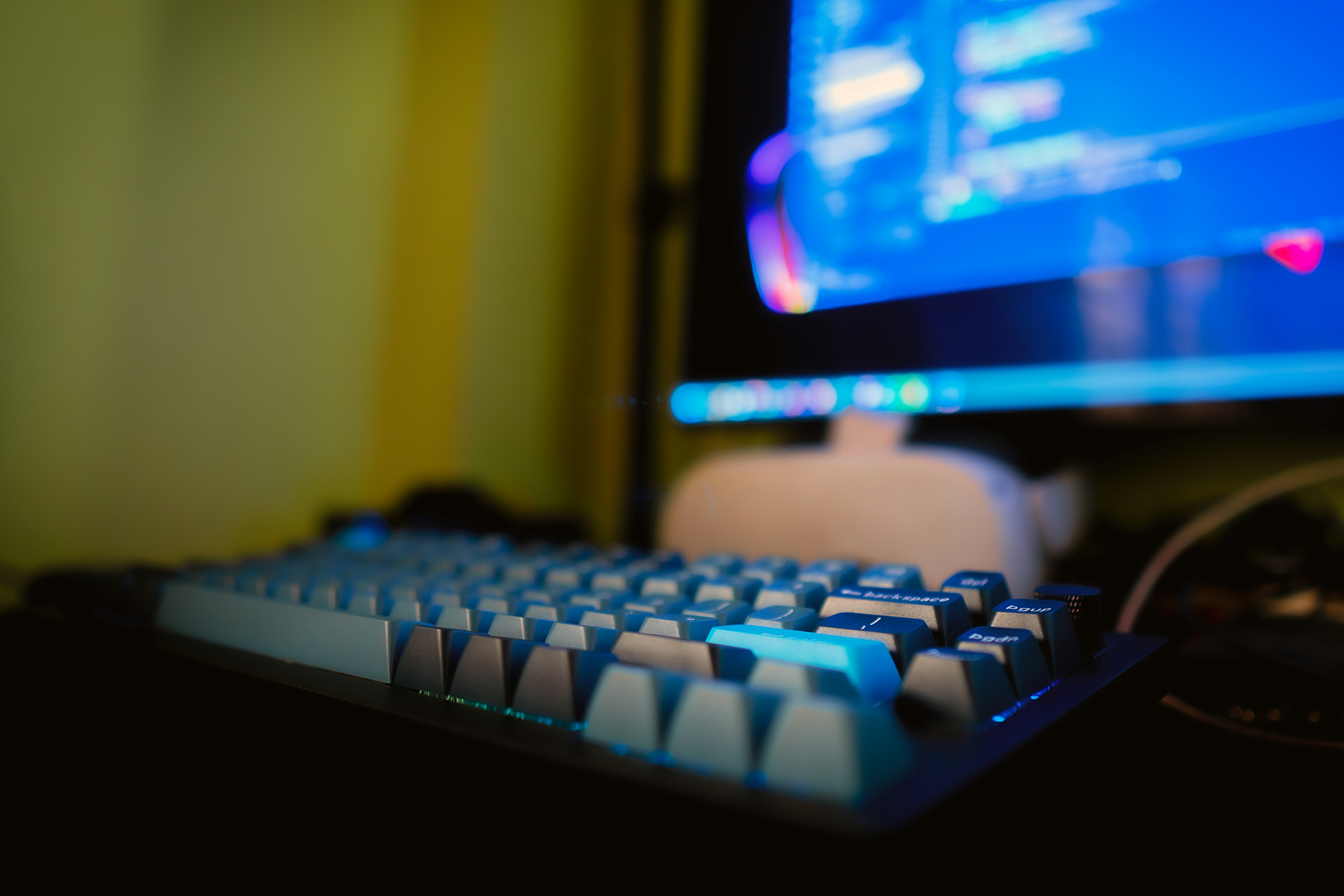 a computer keyboard sitting in front of a monitor