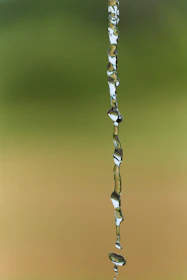 a drop of water falling from a faucet
