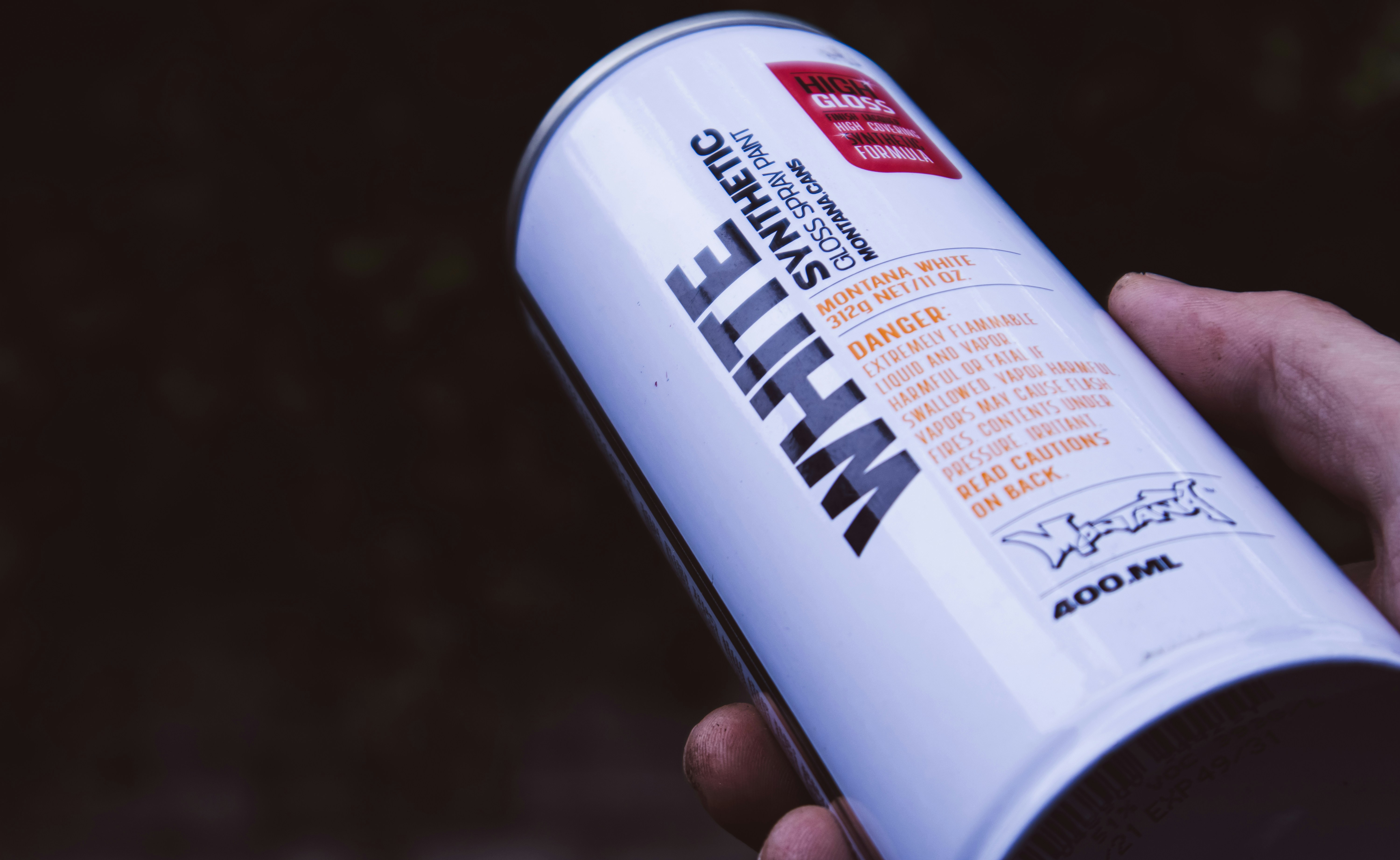 a person holding a can of white stuff