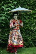 a woman in a costume holding an umbrella