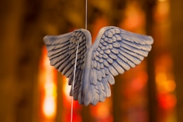 a blue bird ornament hanging from a string