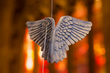 a blue bird ornament hanging from a string