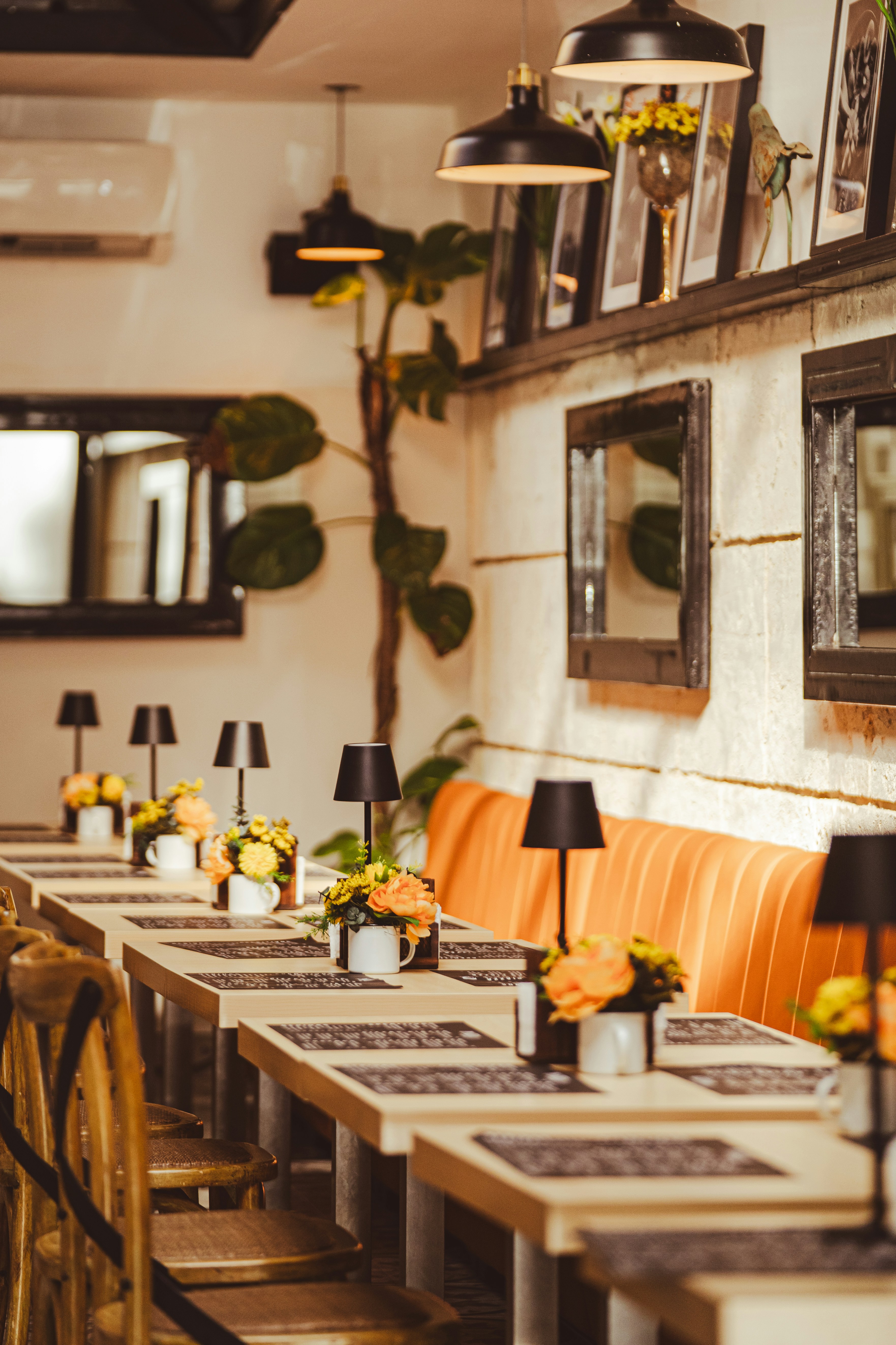 Restaurant dining room with warm lighting and beautifully set tables in bright ambient light