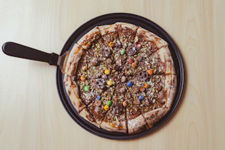 a pizza sitting on top of a pan covered in toppings