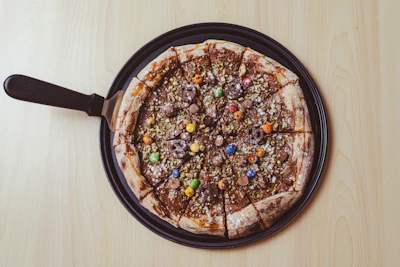 a pizza sitting on top of a pan covered in toppings