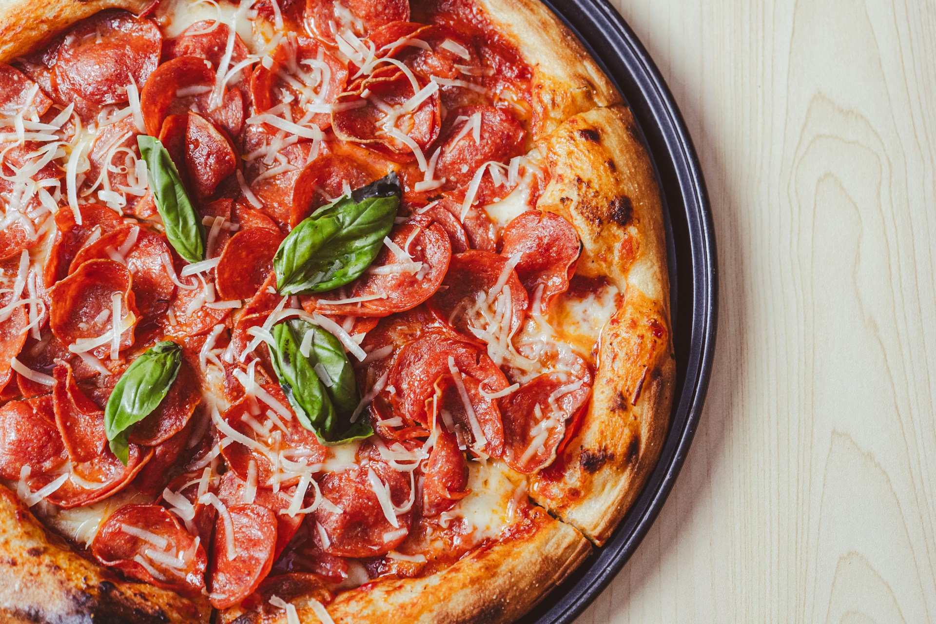 a close up of a pizza on a plate on a table