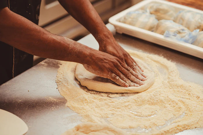 Hand-kneaded pizza dough on a table