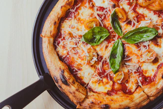 a pizza sitting on top of a pan covered in cheese