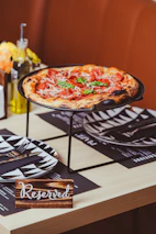 a pizza sitting on top of a metal tray on a table