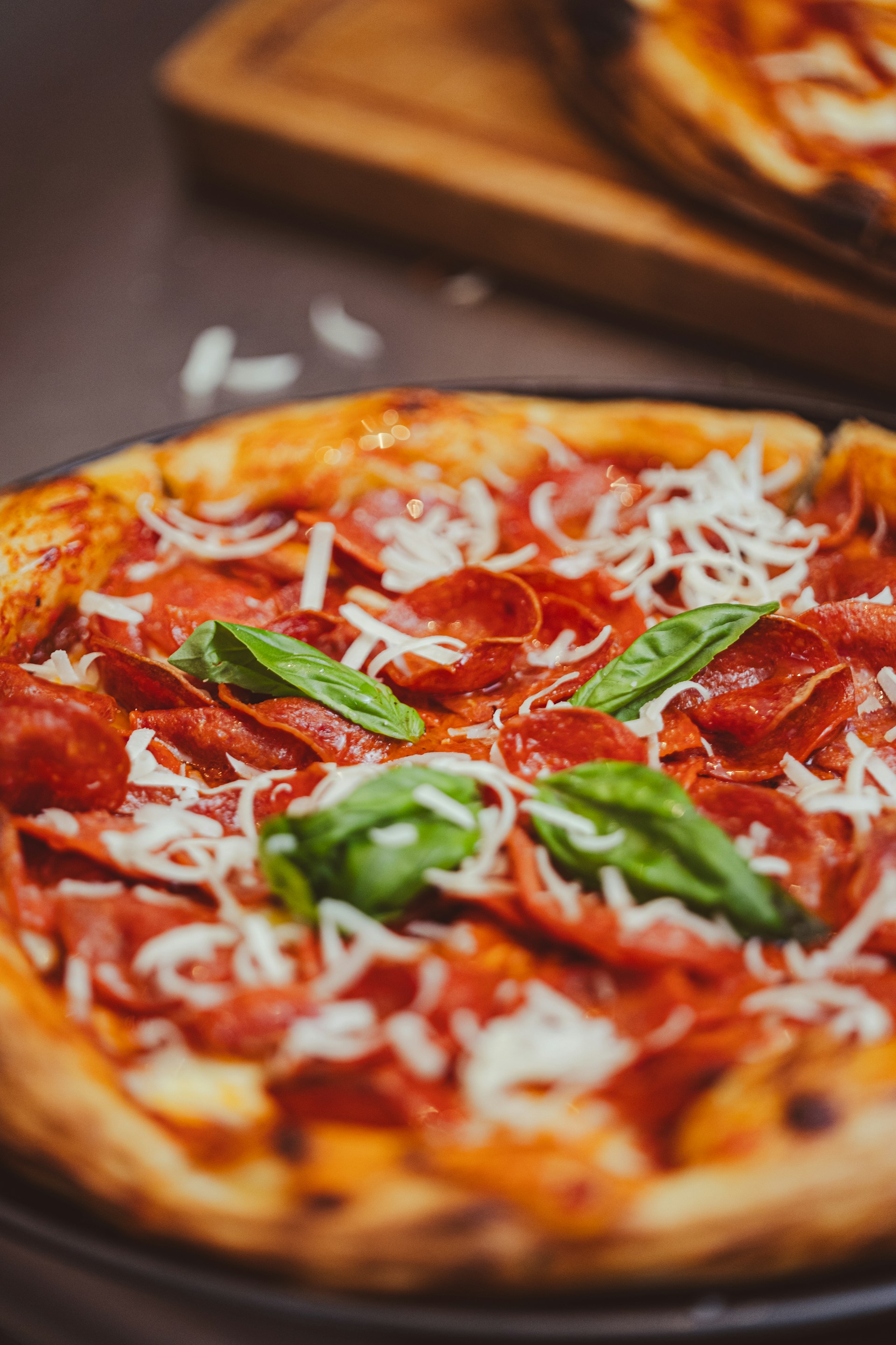 a close up of a pizza on a pan on a table