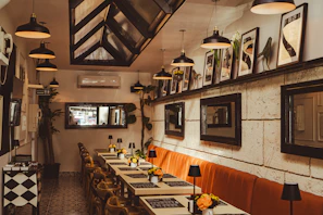 a dining room with tables and chairs and pictures on the wall