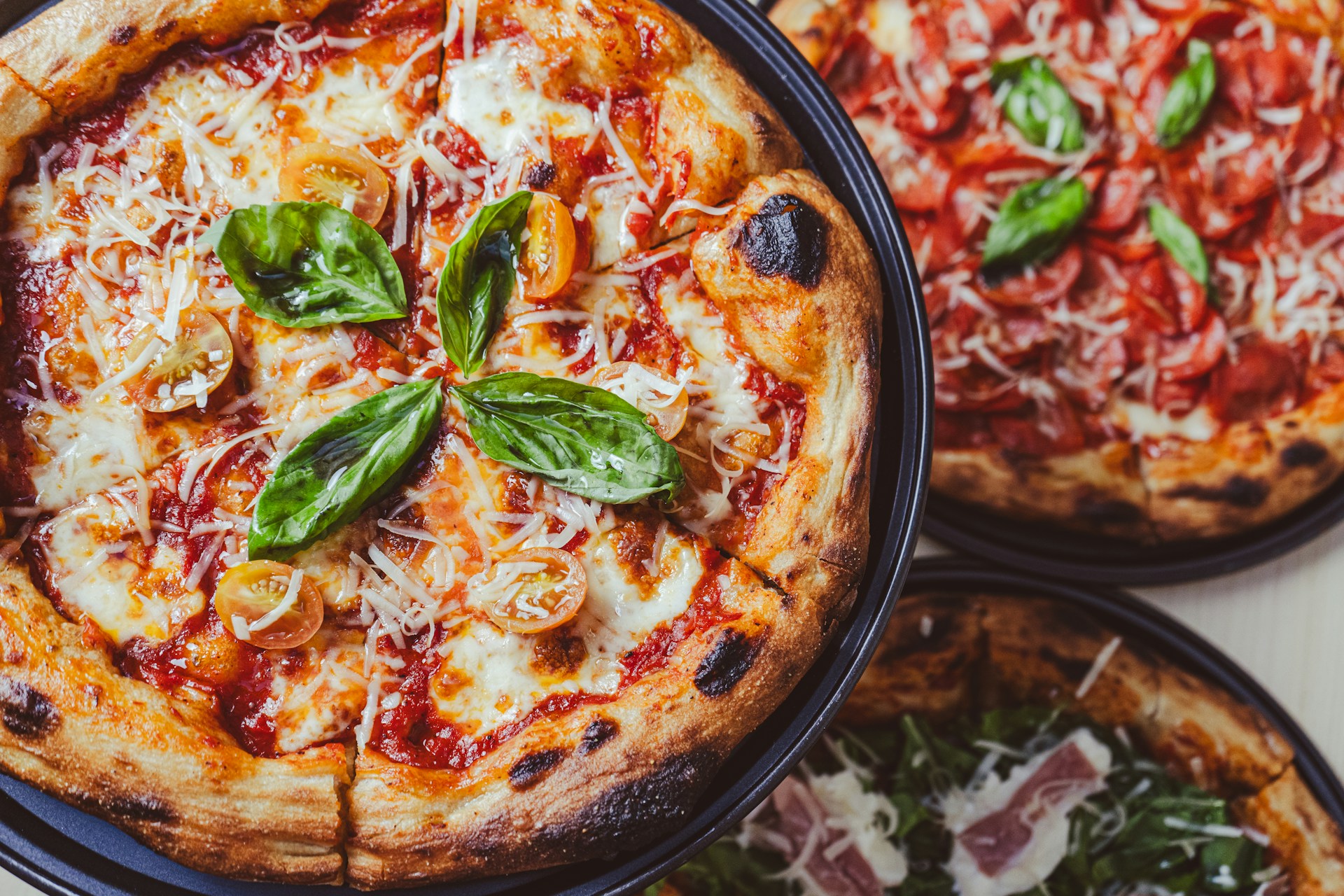 a couple of pizzas sitting on top of a table