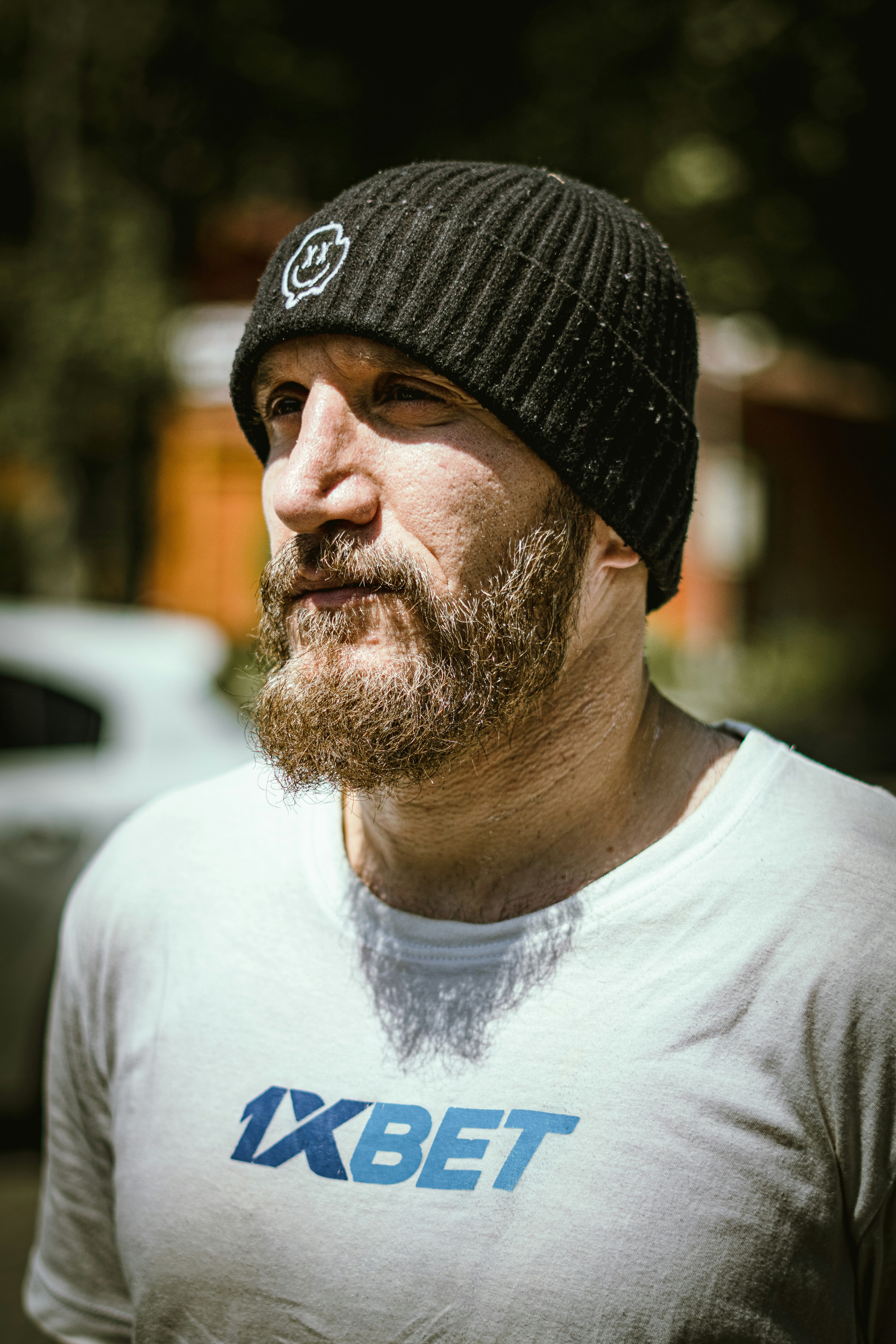 a man with a beard wearing a hat