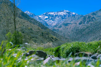 a view of a mountain range with a stream running through it