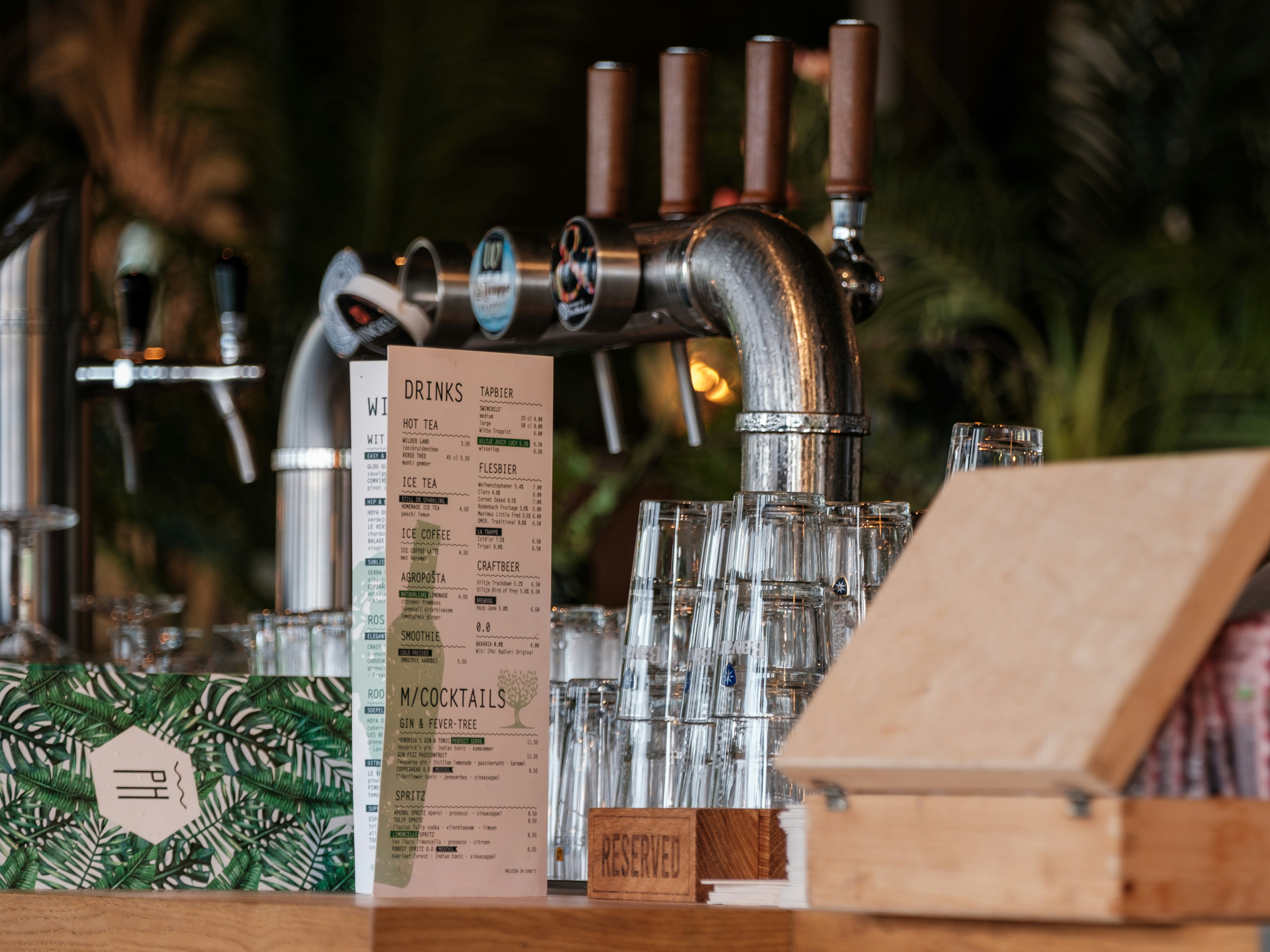 Bar counter with taps and stacked glasses