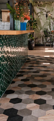 a tiled floor in a restaurant with potted plants