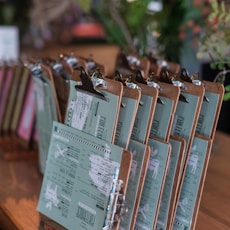 a wooden table topped with lots of clipboards