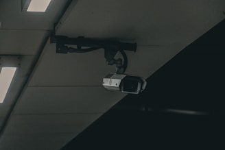 a security camera mounted to the ceiling of a building