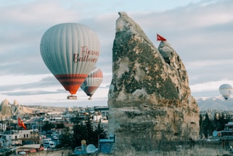 a couple of hot air balloons flying over a city