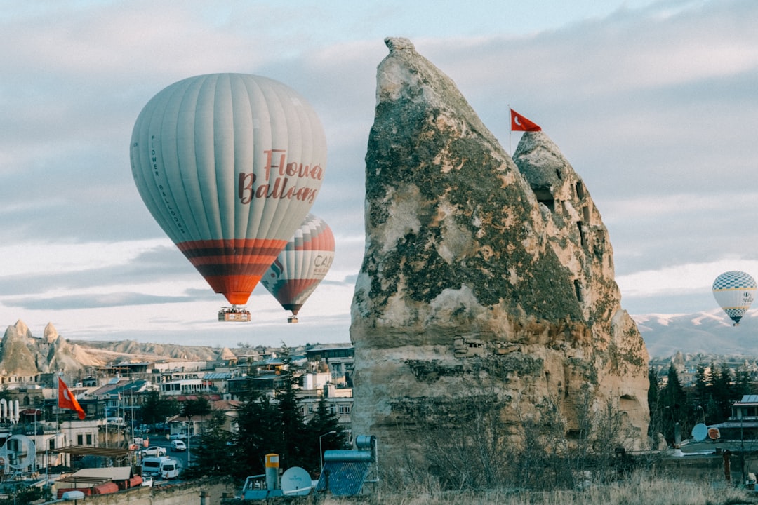 a couple of hot air balloons flying over a city,