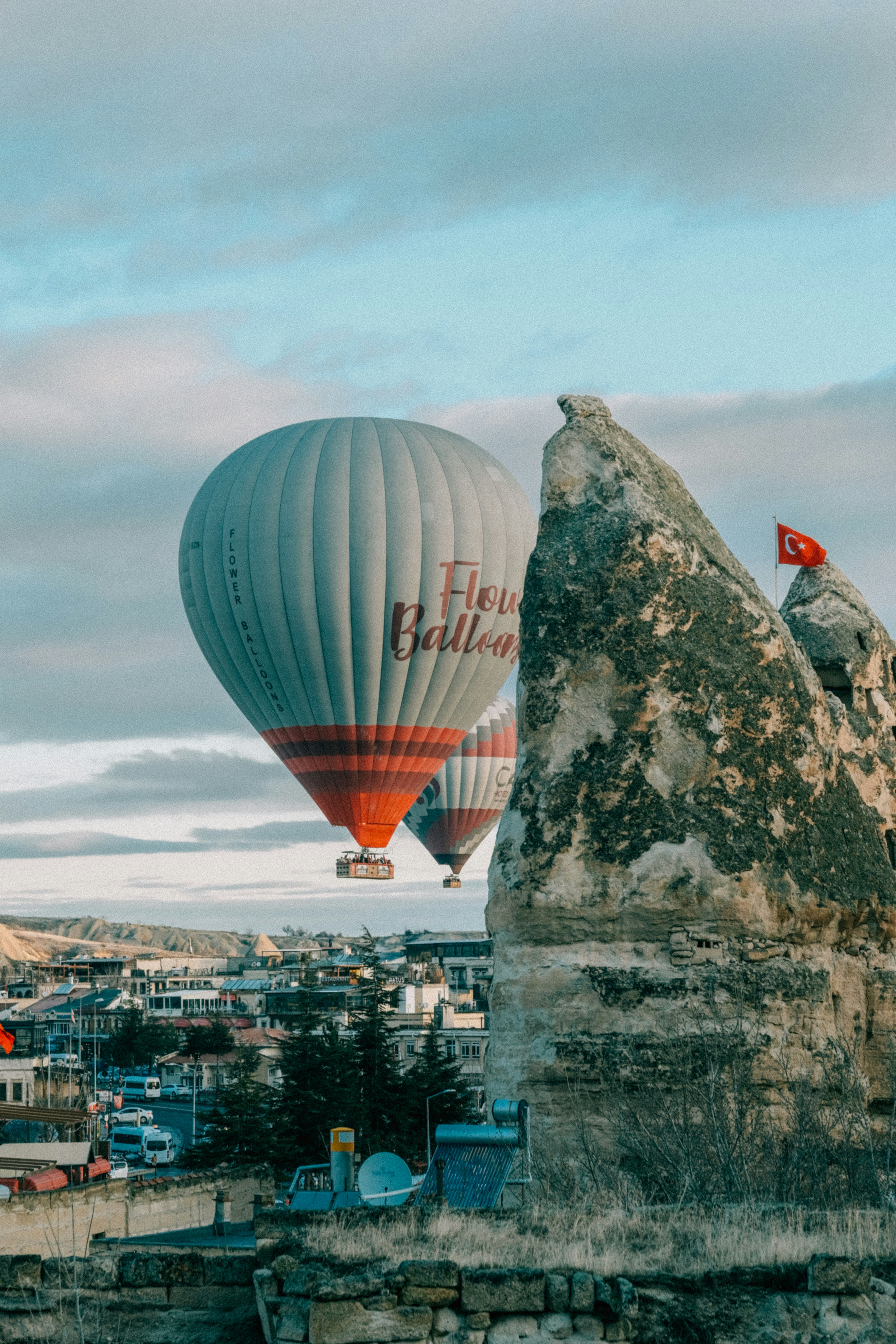 Two hot air balloons flying over a city - Free Photo on Unsplash