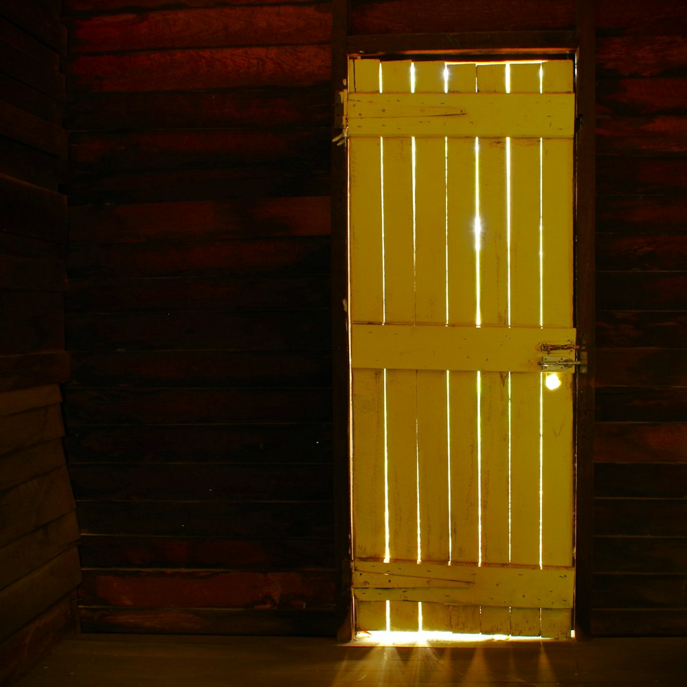 a yellow door with a light shining through it
