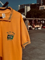 a yellow shirt with a green and white logo on it